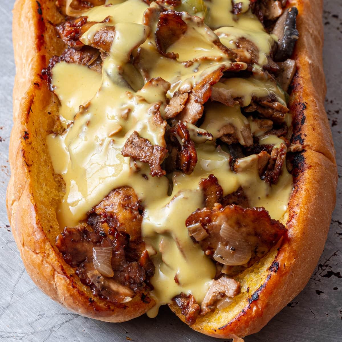 a platter of Philly cheesesteak plant-based meatball subs, ready to serve