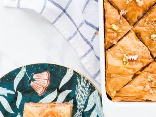 overhead shot of freshly baked spiced pumpkin baklava, drizzled with syrup