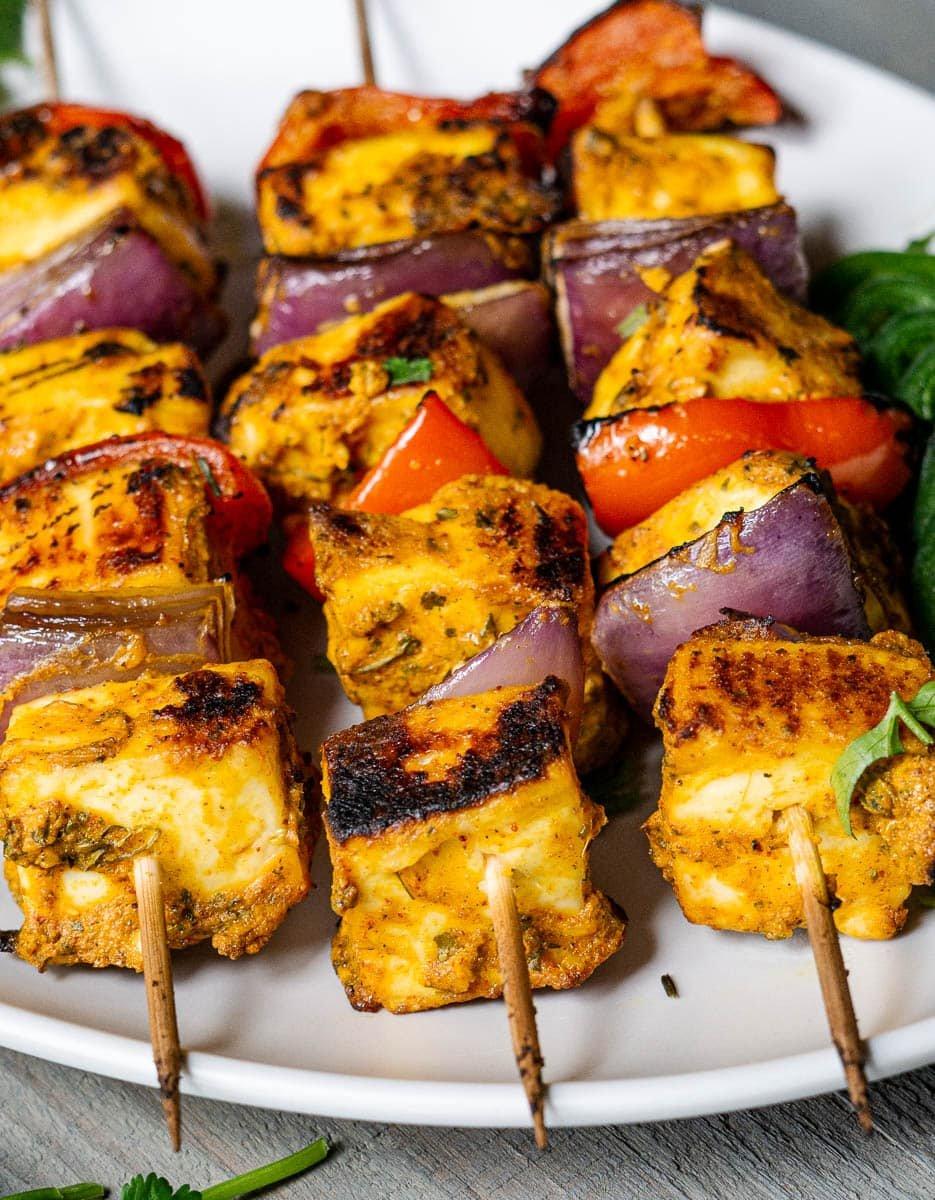 Close-up of Sweet Chili Paneer Tikka on skewers