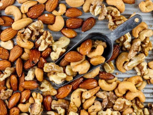 various toasted nuts (almonds, pecans, cashews) on a baking sheet
