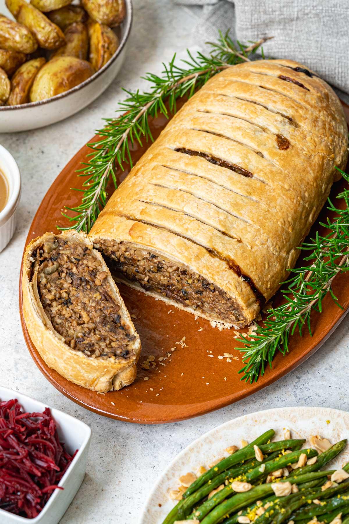 Vegan Boursin and Mushroom Wellington golden brown and sliced open