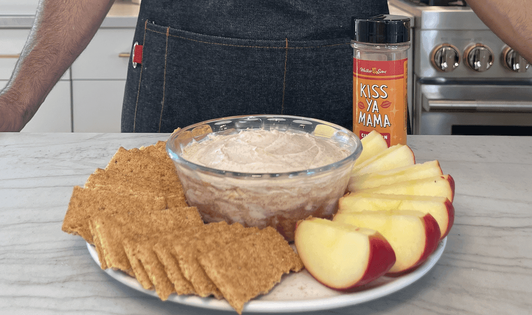 cinnamon roll dip with cream cheese frosting served with graham crackers and apple slices