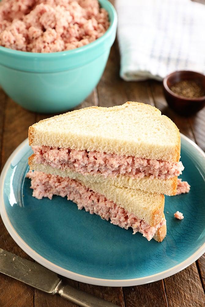 Ingredients for deviled ham and swiss sandwich, including ham, swiss cheese, mayonnaise, mustard, spices, and bread.