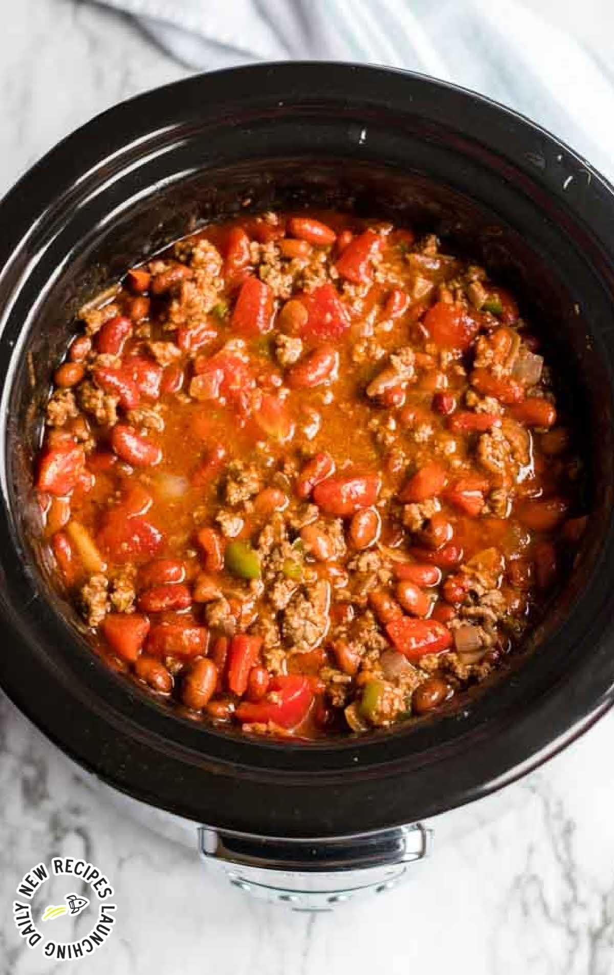 Close-up shot of a simmering slow cooker filled with chili