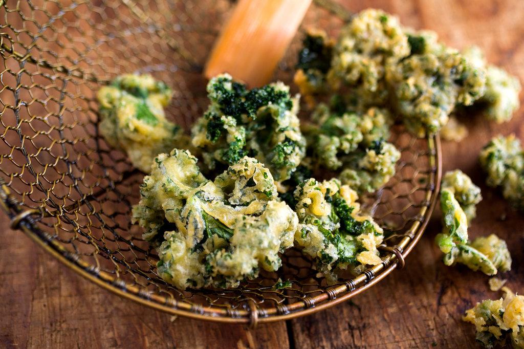 a bowl of frosted black kale and lime chips being served