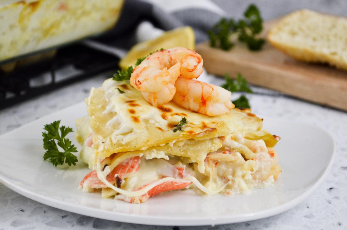 Lobster lasagna being served on a plate, top view