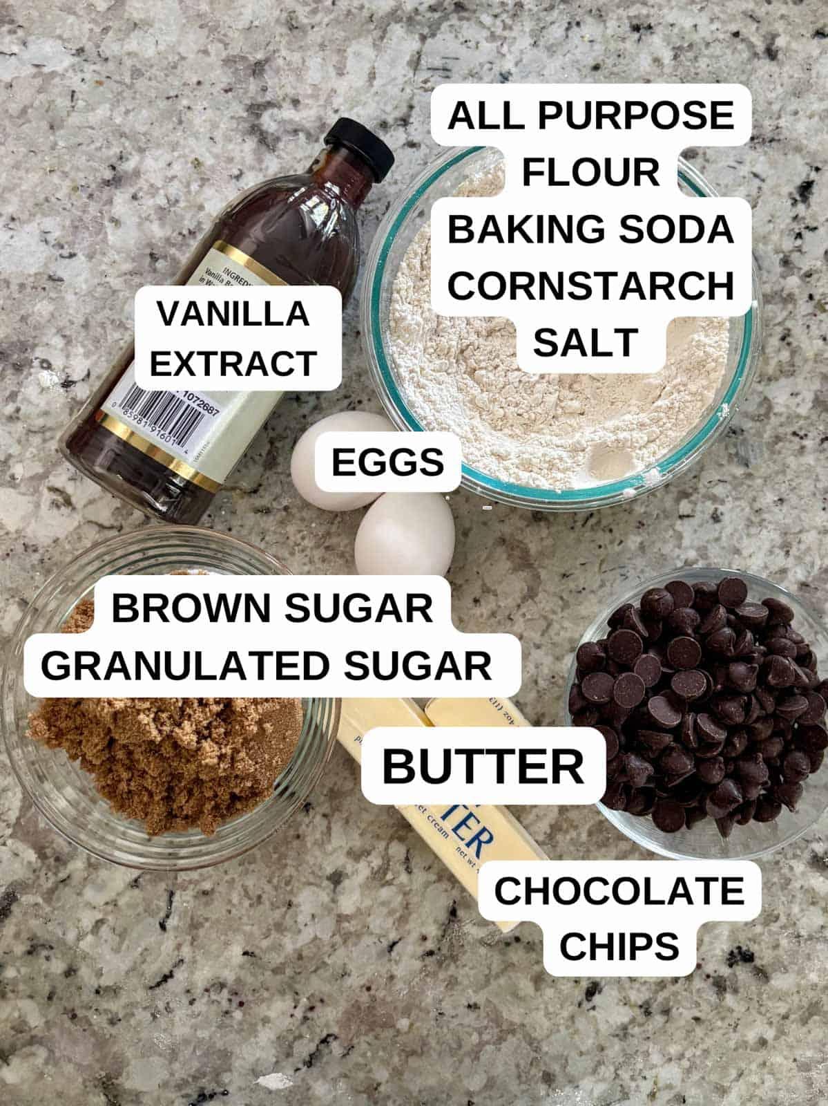 ingredients for chocolate cookies laid out on a wooden counter, ready for baking