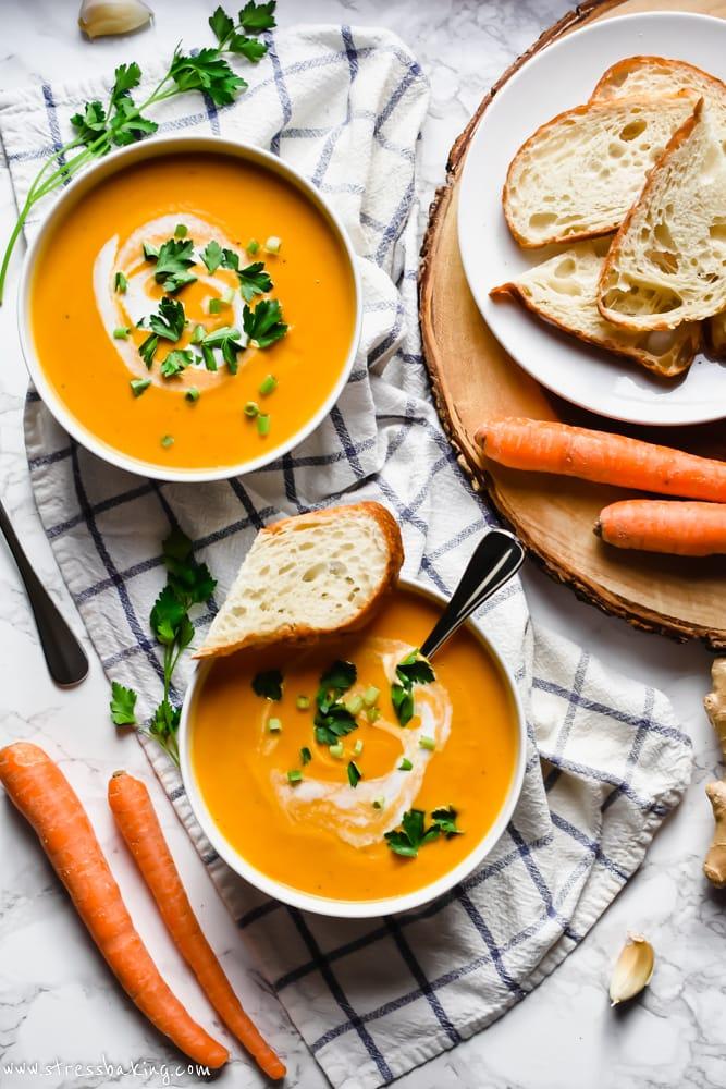 Overhead shot of a person enjoying a bowl of carrot ginger soup