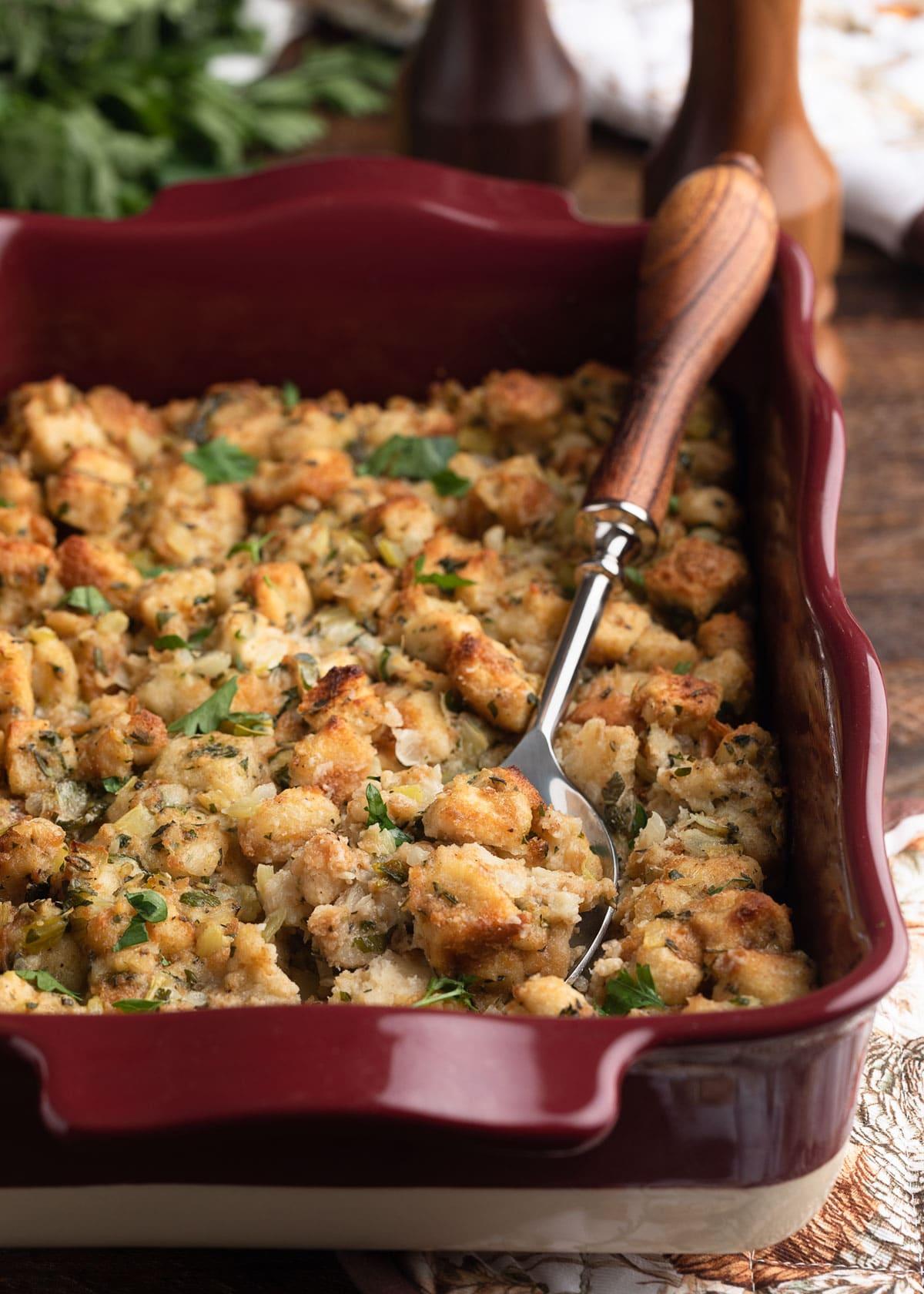 Rustic Thanksgiving bread stuffing with herbs in a baking dish, ready to serve