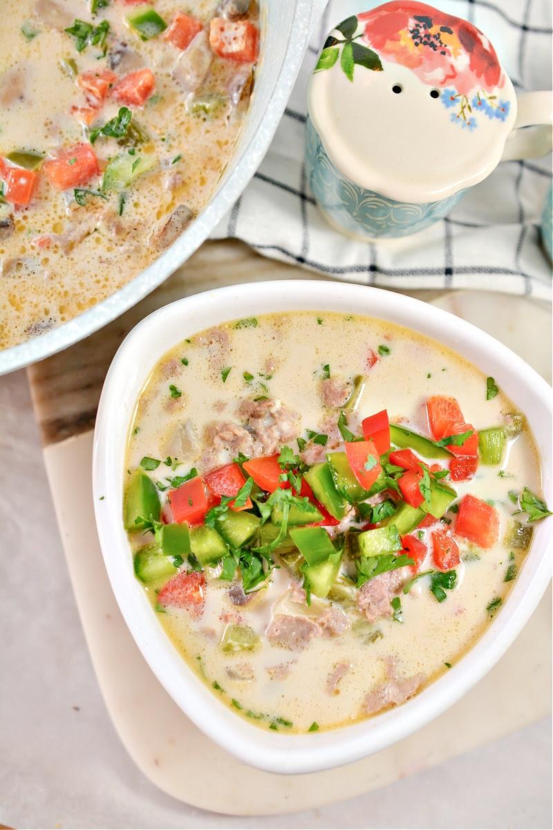 A bowl of Keto Philly Cheesesteak Soup with melted cheese and parsley on top