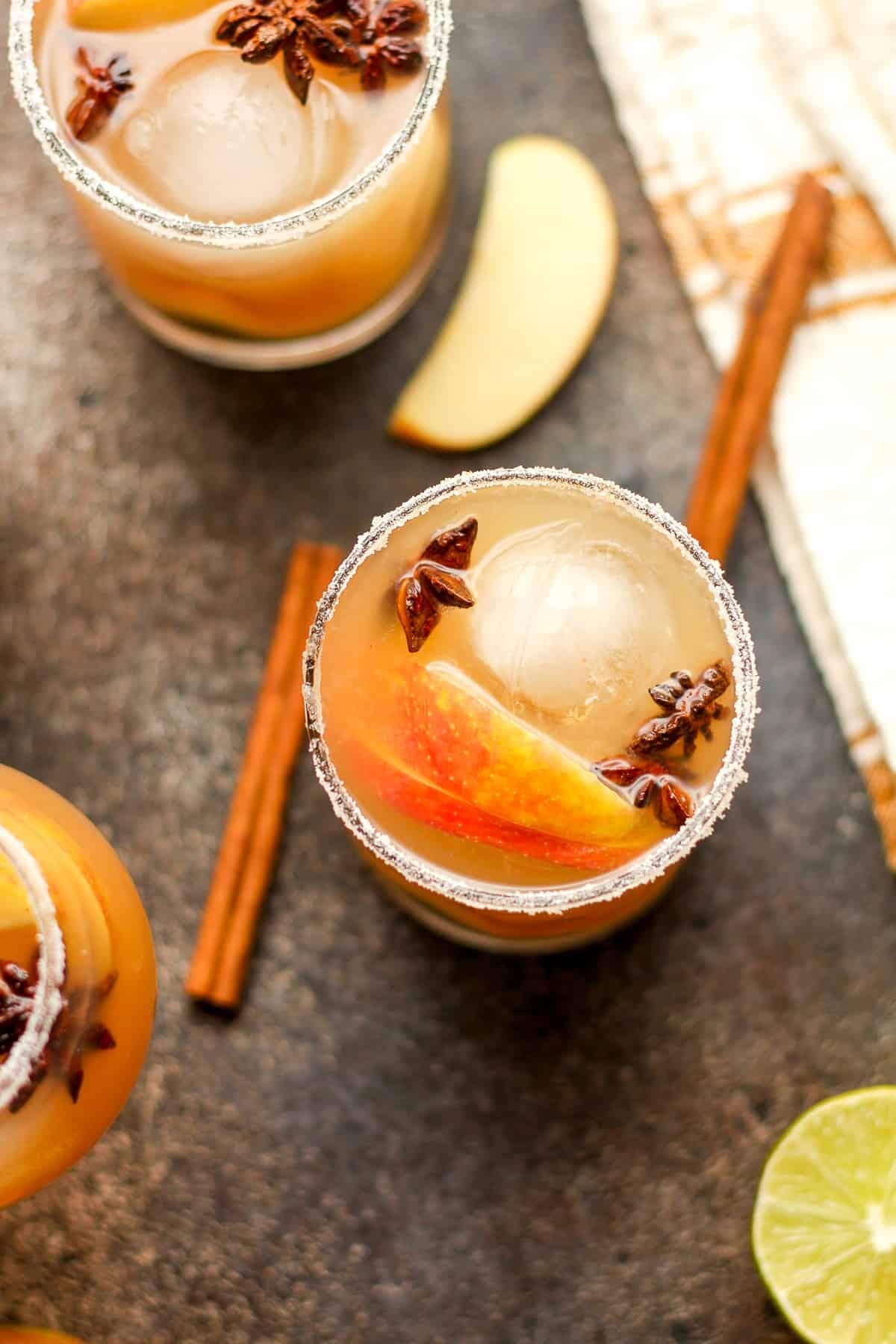 Overhead shot of a whole apple crisp with a glass of tequila beside it