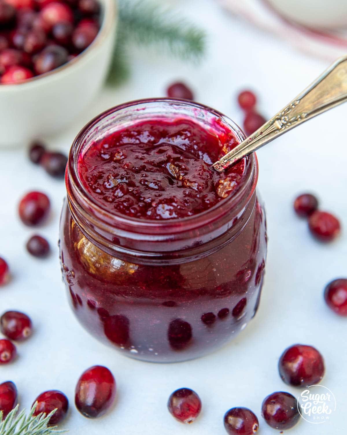 homemade cranberry sauce cooling in a glass jar