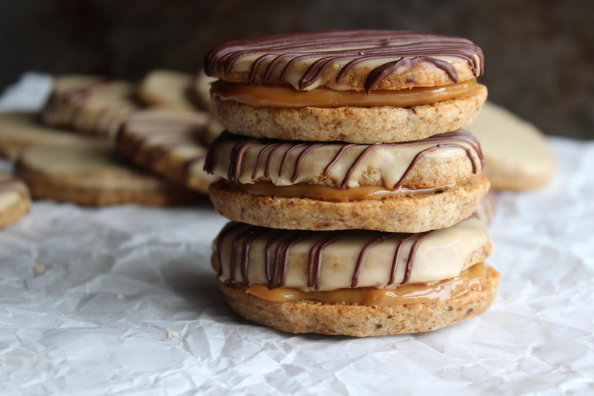 Warm espresso shortbread cookies being taken out of the oven, golden brown edges visible, focus on texture