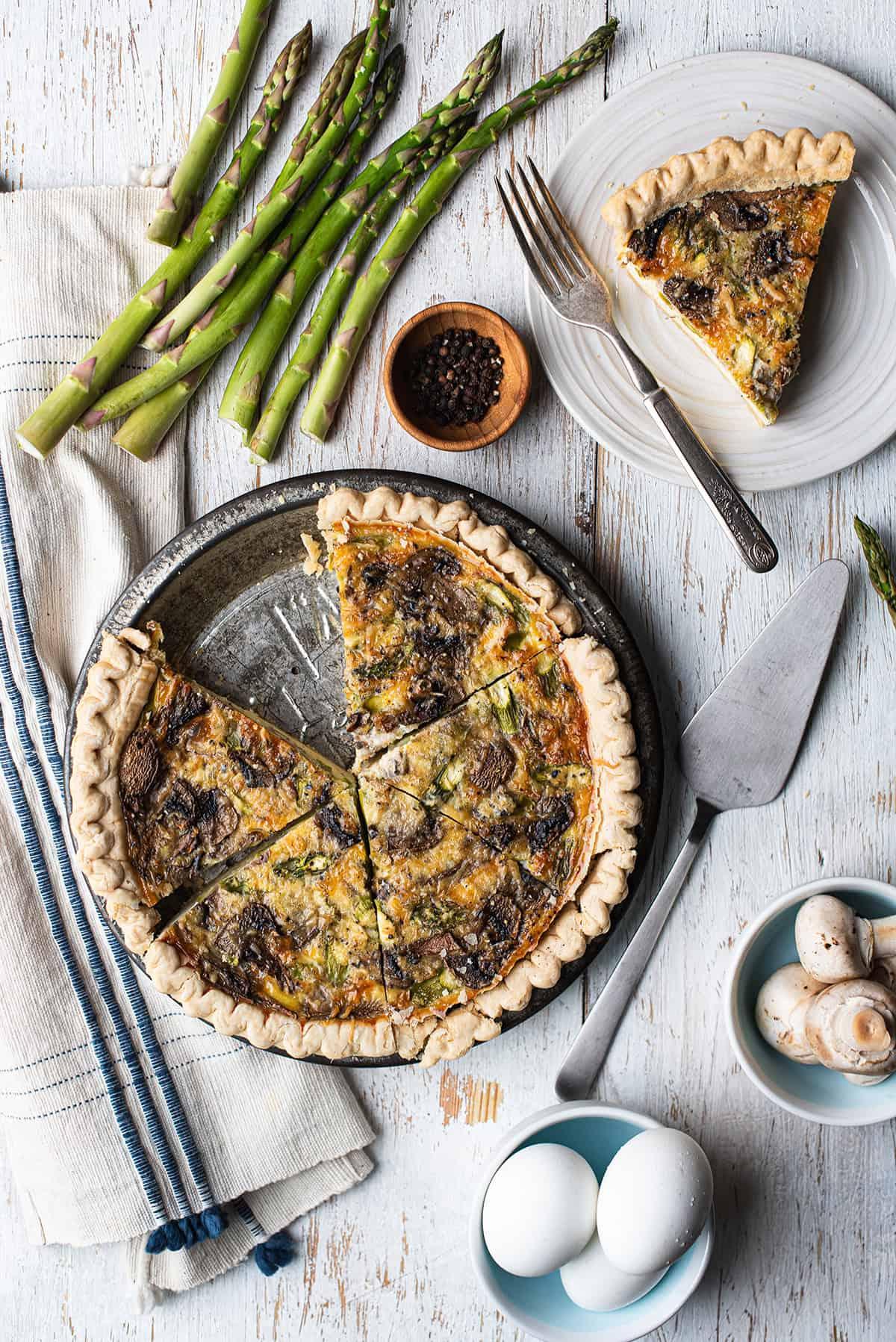 Boiled Egg and Asparagus Quiche on a wooden table