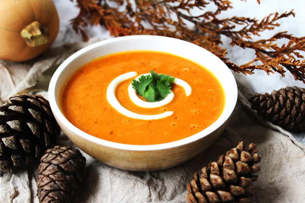 Close-up of a steaming bowl of gingerbread spiced pumpkin soup