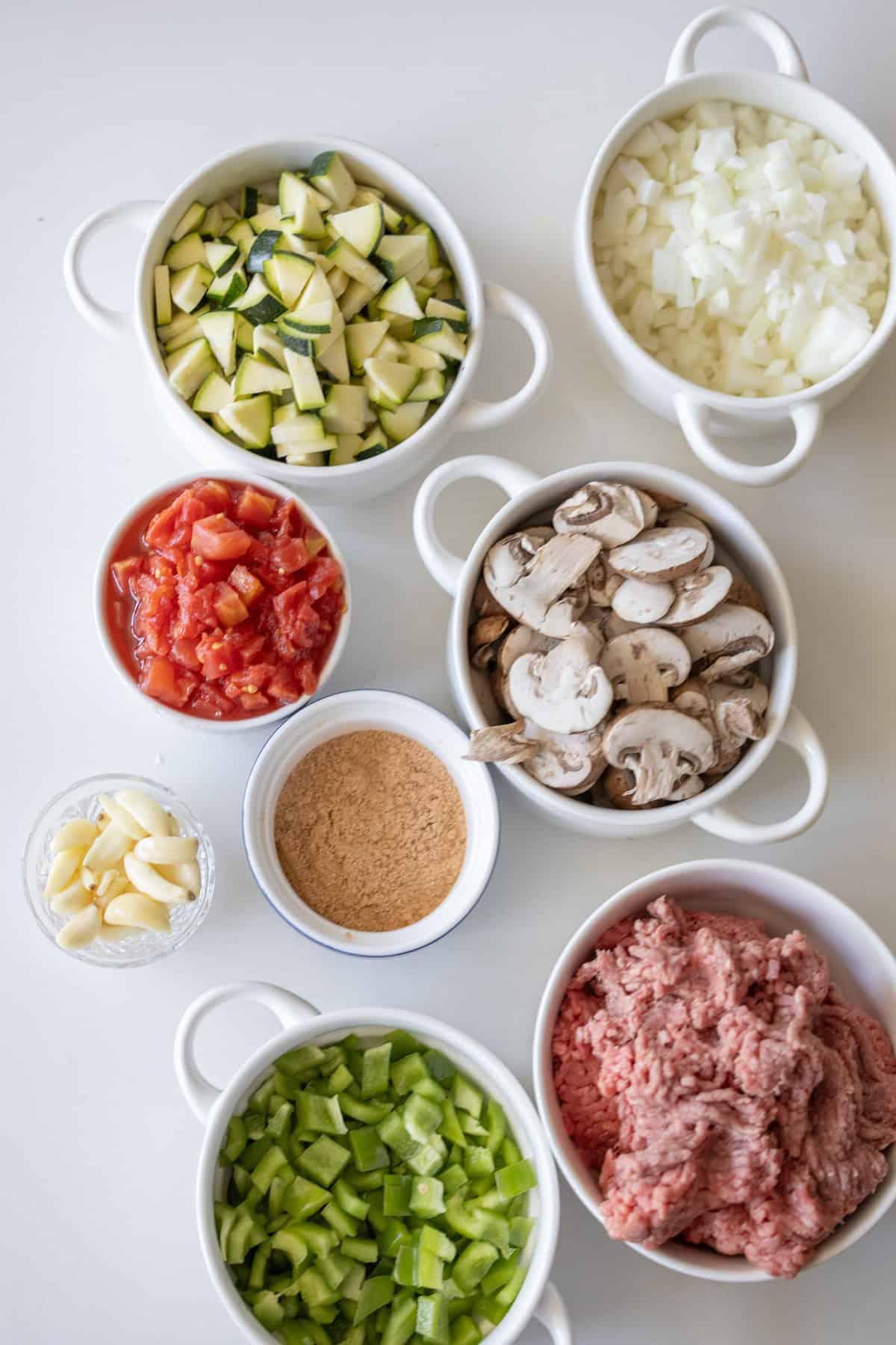 taco ingredients arranged around a skillet