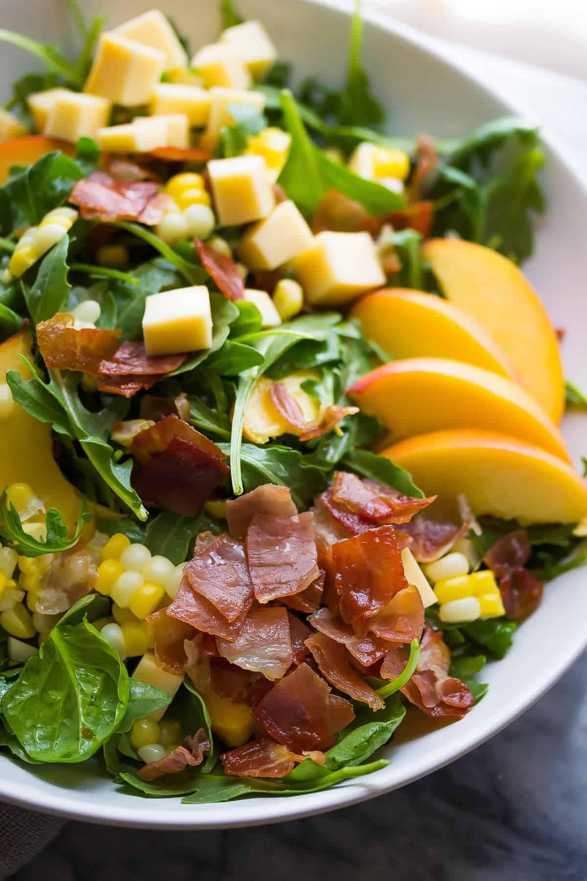 Close-up shot of Grilled Corn and Fig Salad with Prosciutto, highlighting the textures and colors