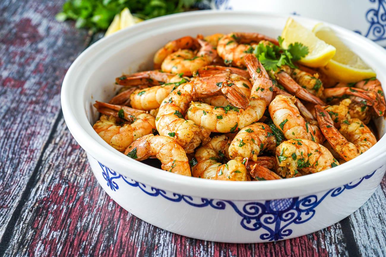 A vibrant and flavorful Spicy Shrimp Tagine with Saffron and Cilantro, garnished with fresh cilantro and a sprinkle of saffron threads.