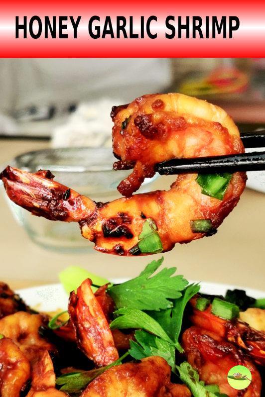 Sizzling honey garlic shrimp in a pan, actively cooking and coated in sauce