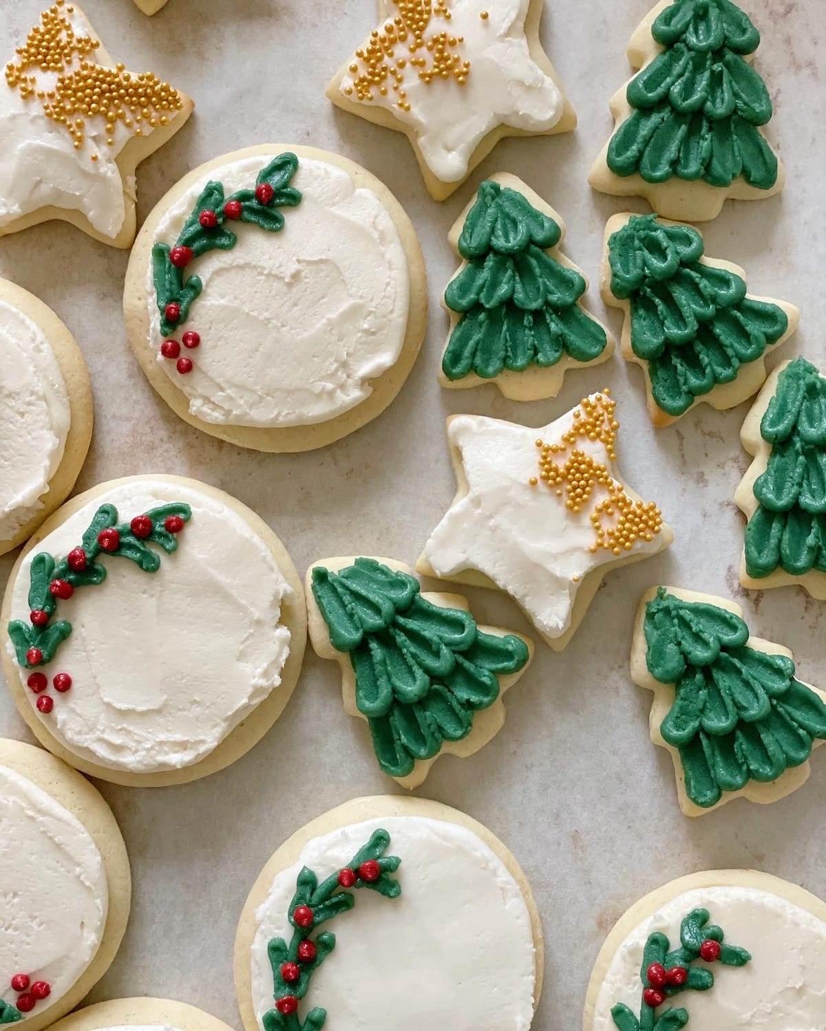beautifully decorated Christmas french tip sugar cookies on a festive plate