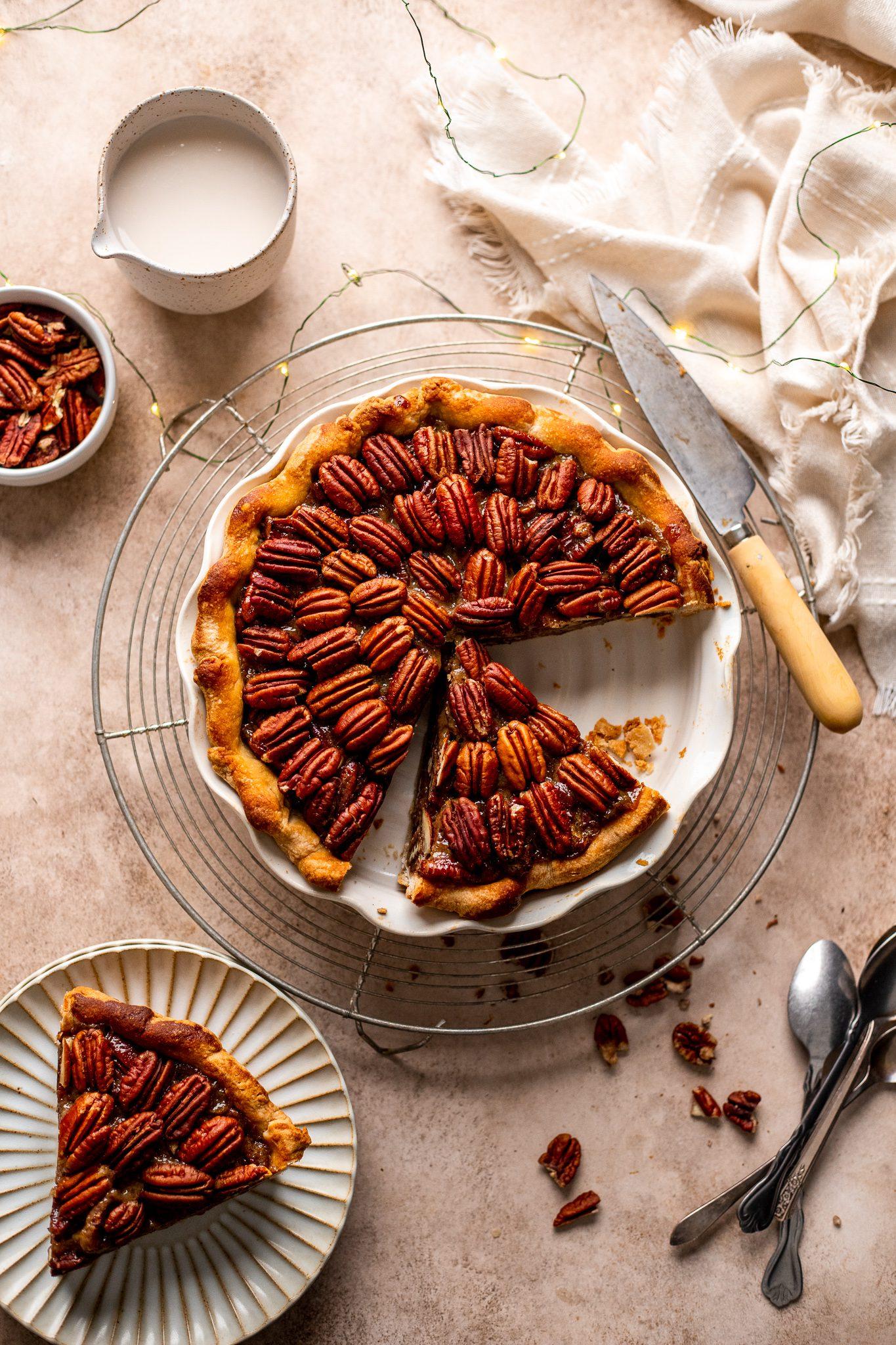 a group of people enjoying slices of plantain and pecan pie at a dinner table