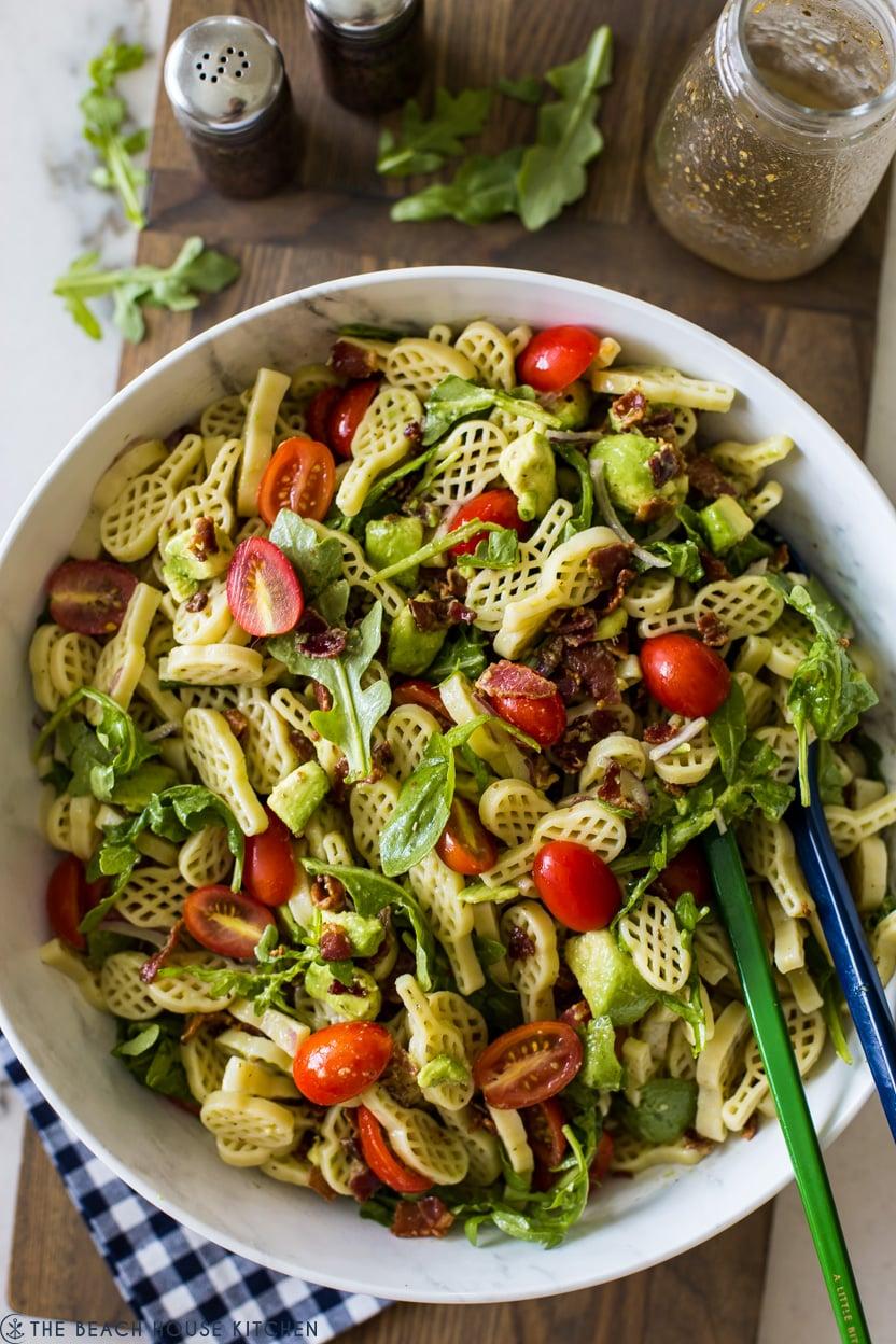 Close-up shot of BLT pasta salad with avocado, highlighting the textures