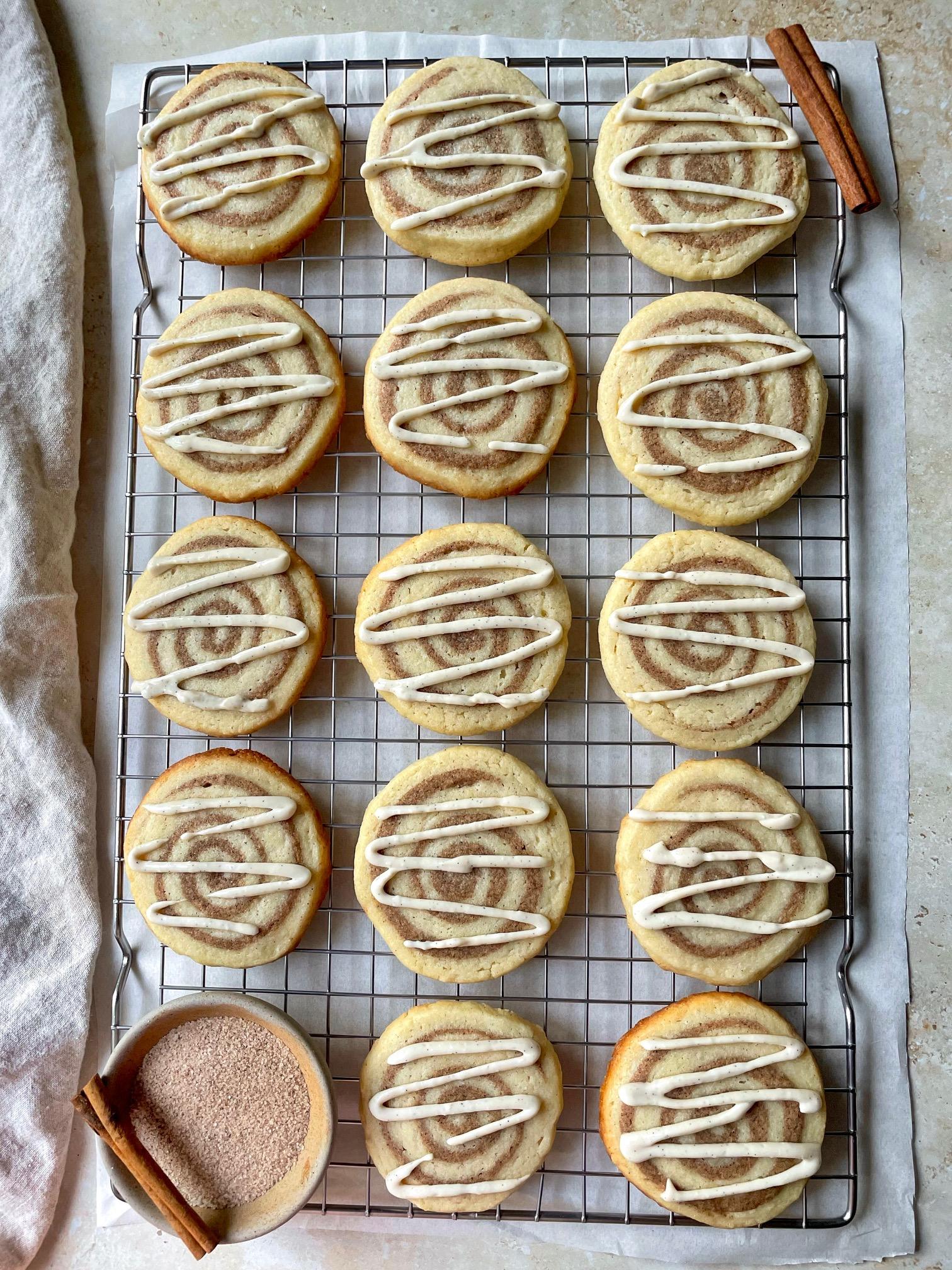 overhead shot of warm cinnamon cookie squares on a cooling rack, some with a bite taken out