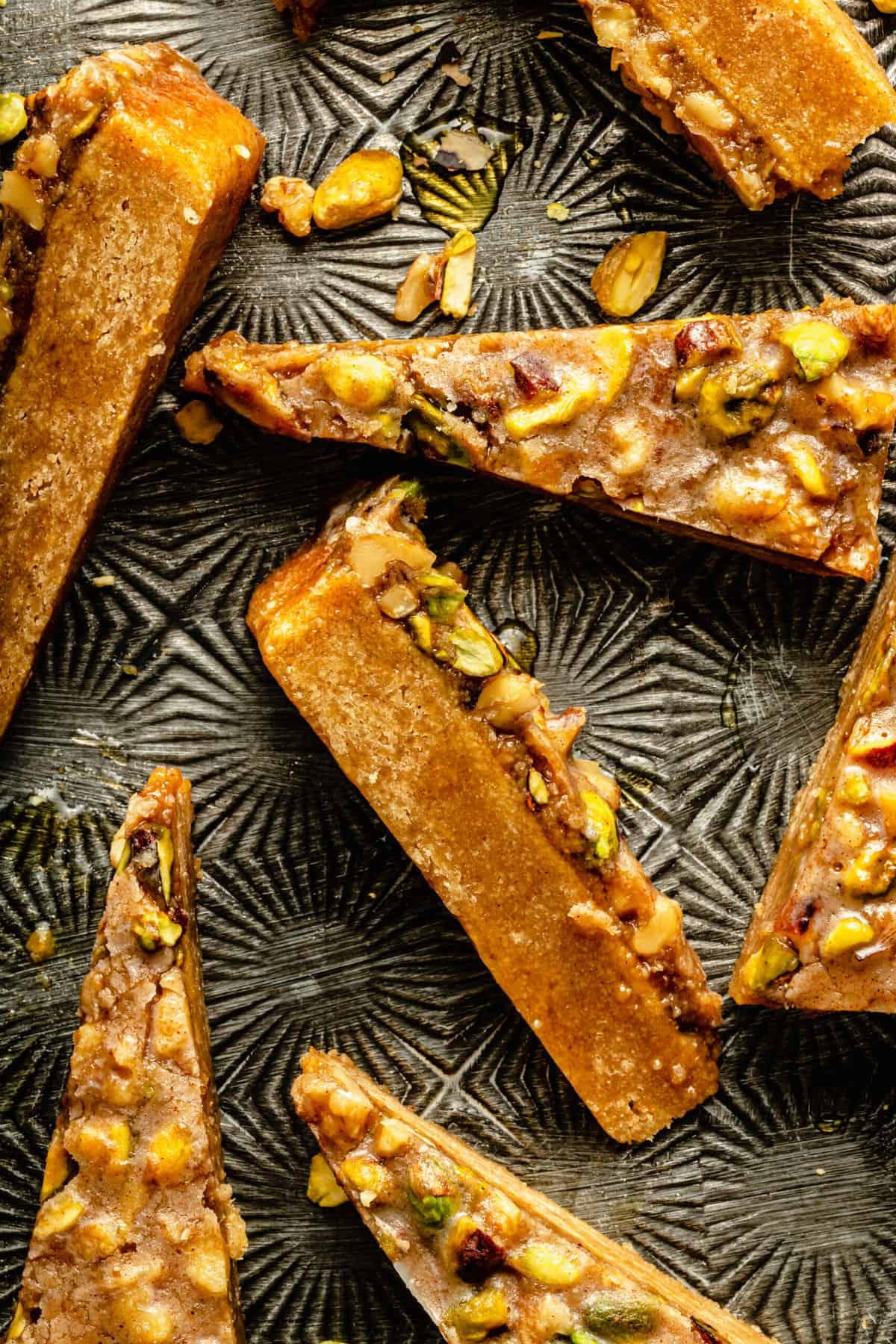close-up of layered baklava bars with dates and almonds