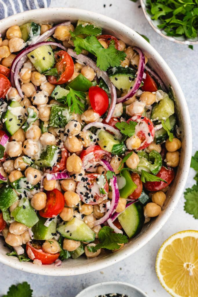 close-up shot of watermelon and chickpea salad with tahini dressing, showing the textures and ingredients