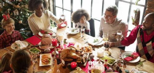Family gathered around a festive table with various drinks, including a sparkling mocktail