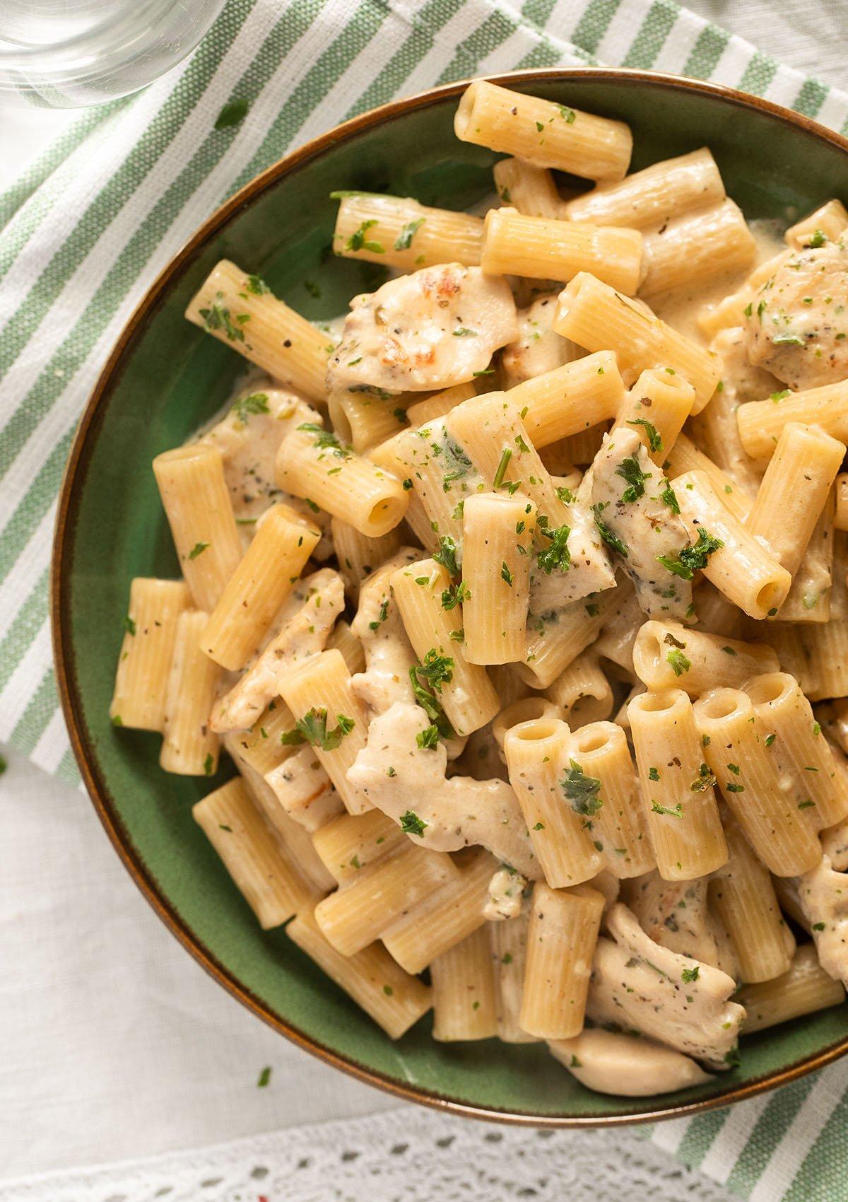 close up of garlic parmesan chicken and noodles in a pot