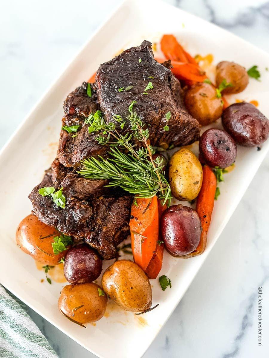 beef pot roast with root vegetables served in a dutch oven