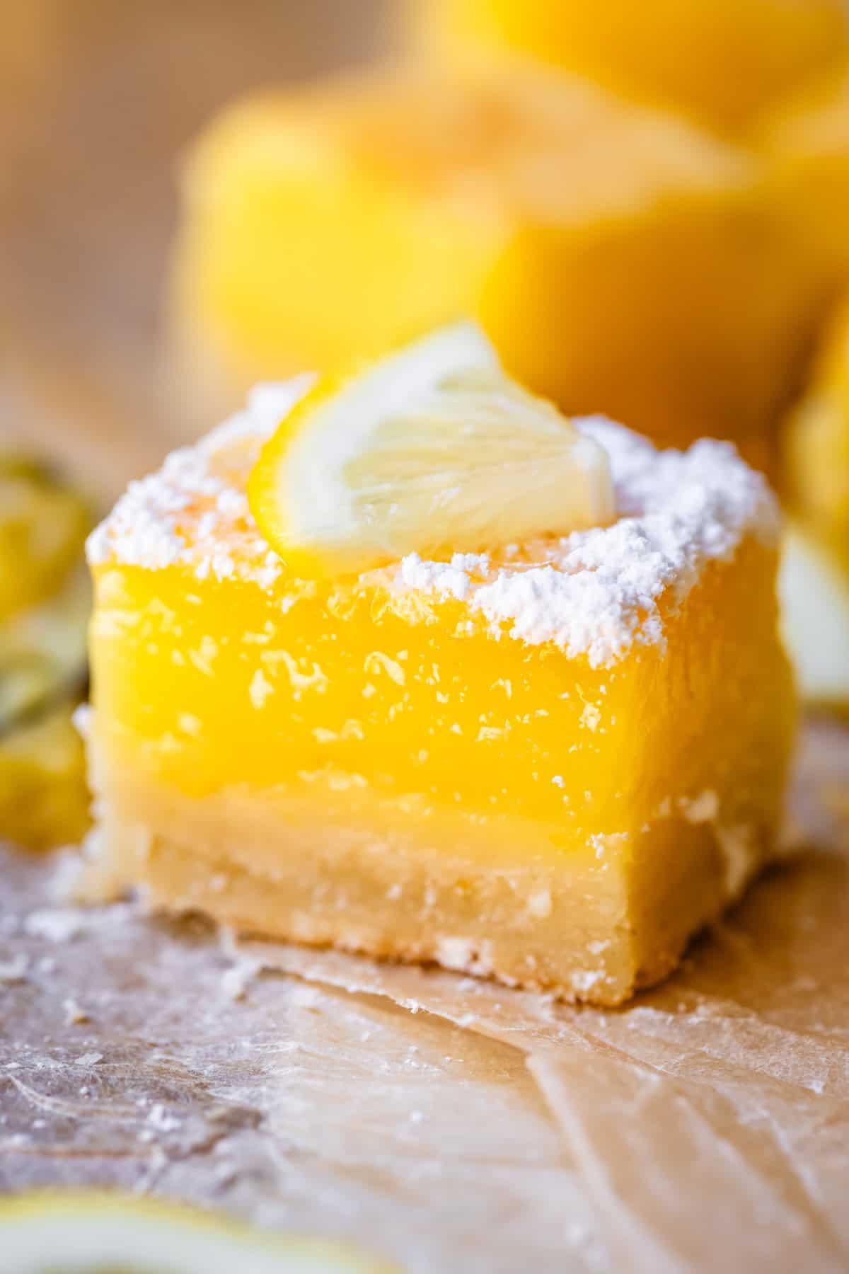 close up shot of lemon bars showing the texture of the crust and custard