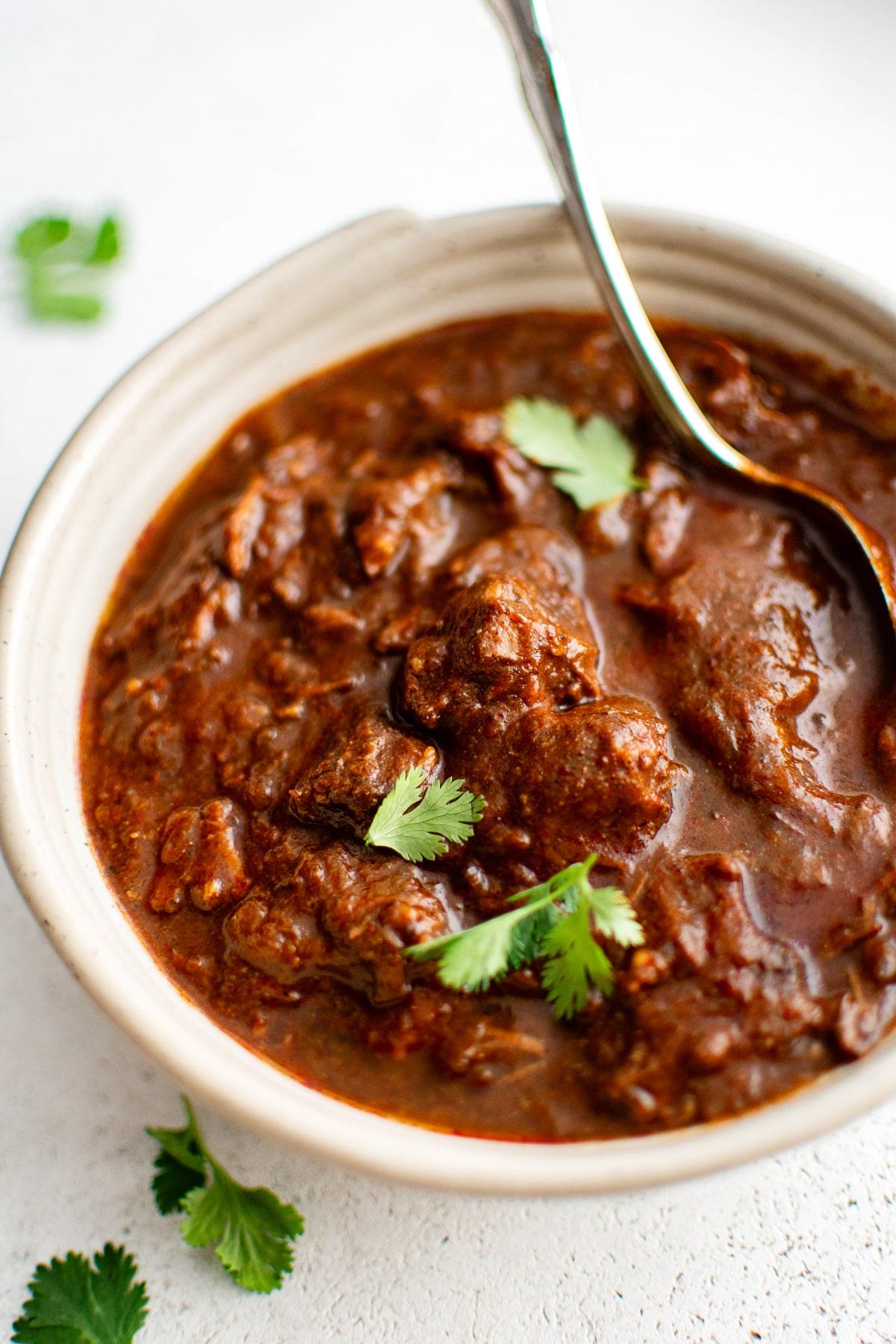 close up shot of a pot of Texas chili simmering on the stove