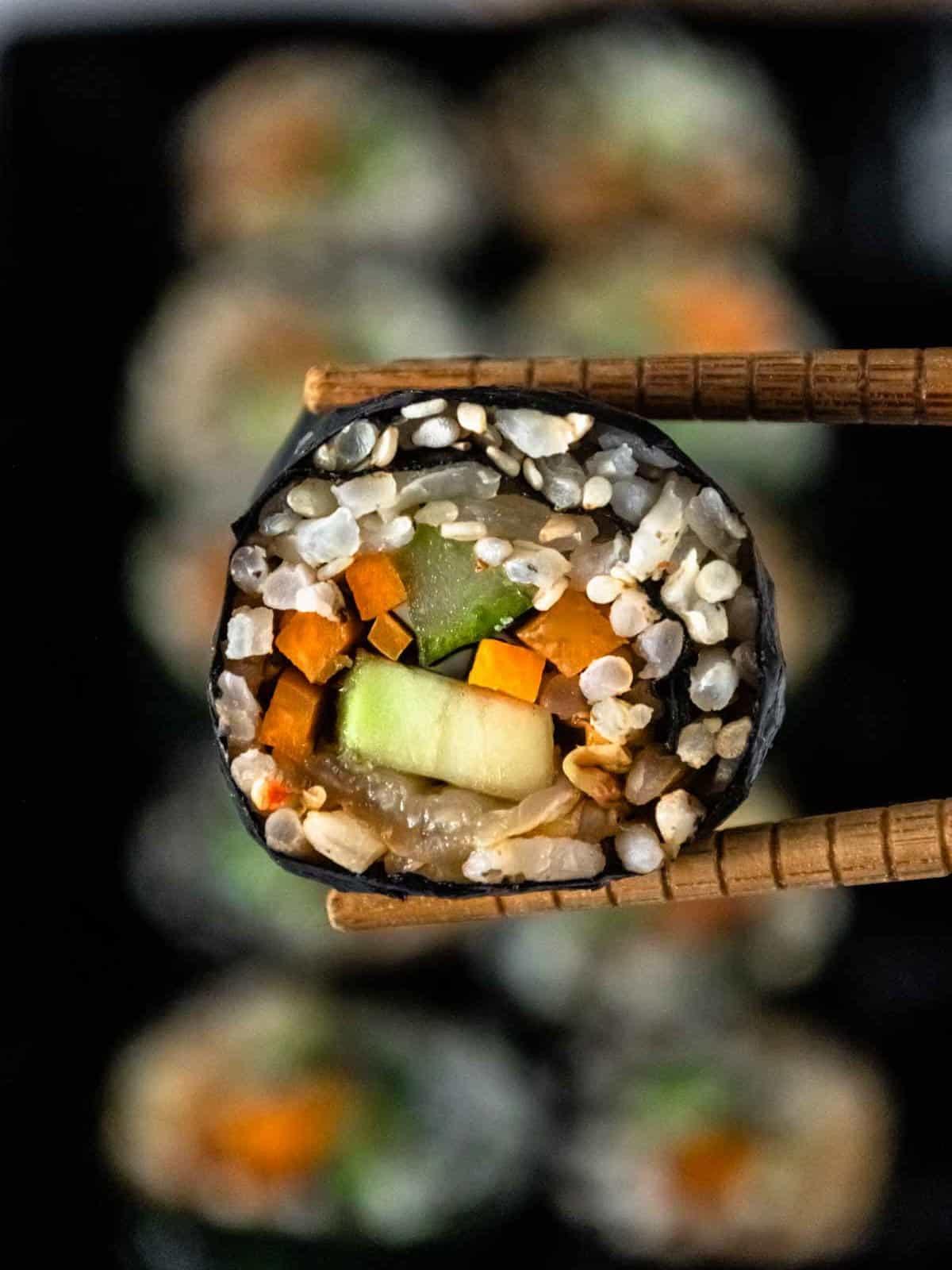 Close-up of someone assembling sauerkraut sushi rolls