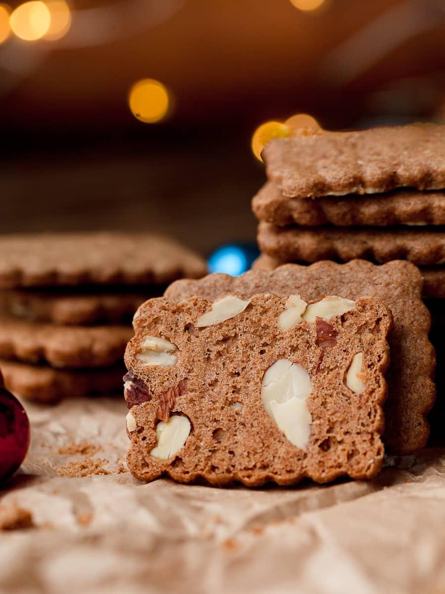 golden brown almond cookies with crisp edges on a cooling rack, sunlight, rustic kitchen