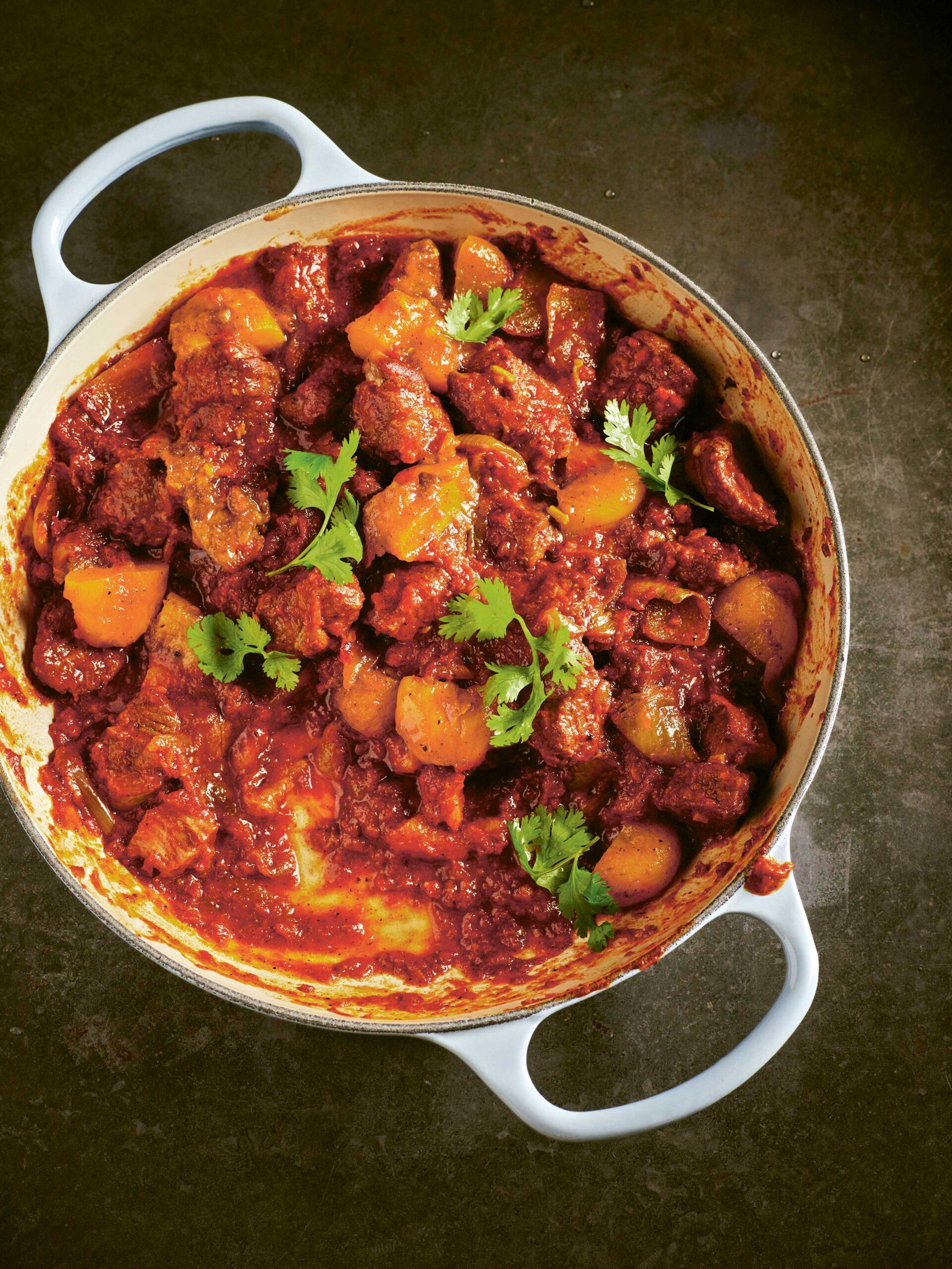 Close-up of a steaming Moroccan tagine with tender lamb and juicy apricots