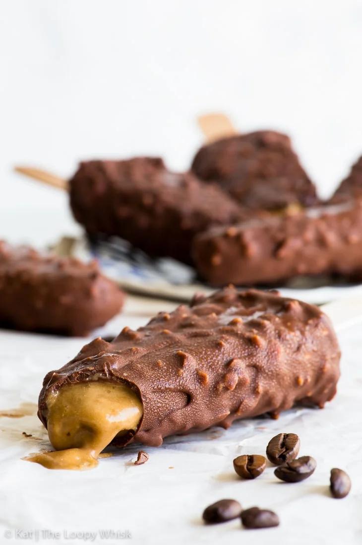 Close-up of a single dairy-free crunch bar ice cream bar with a bite taken out
