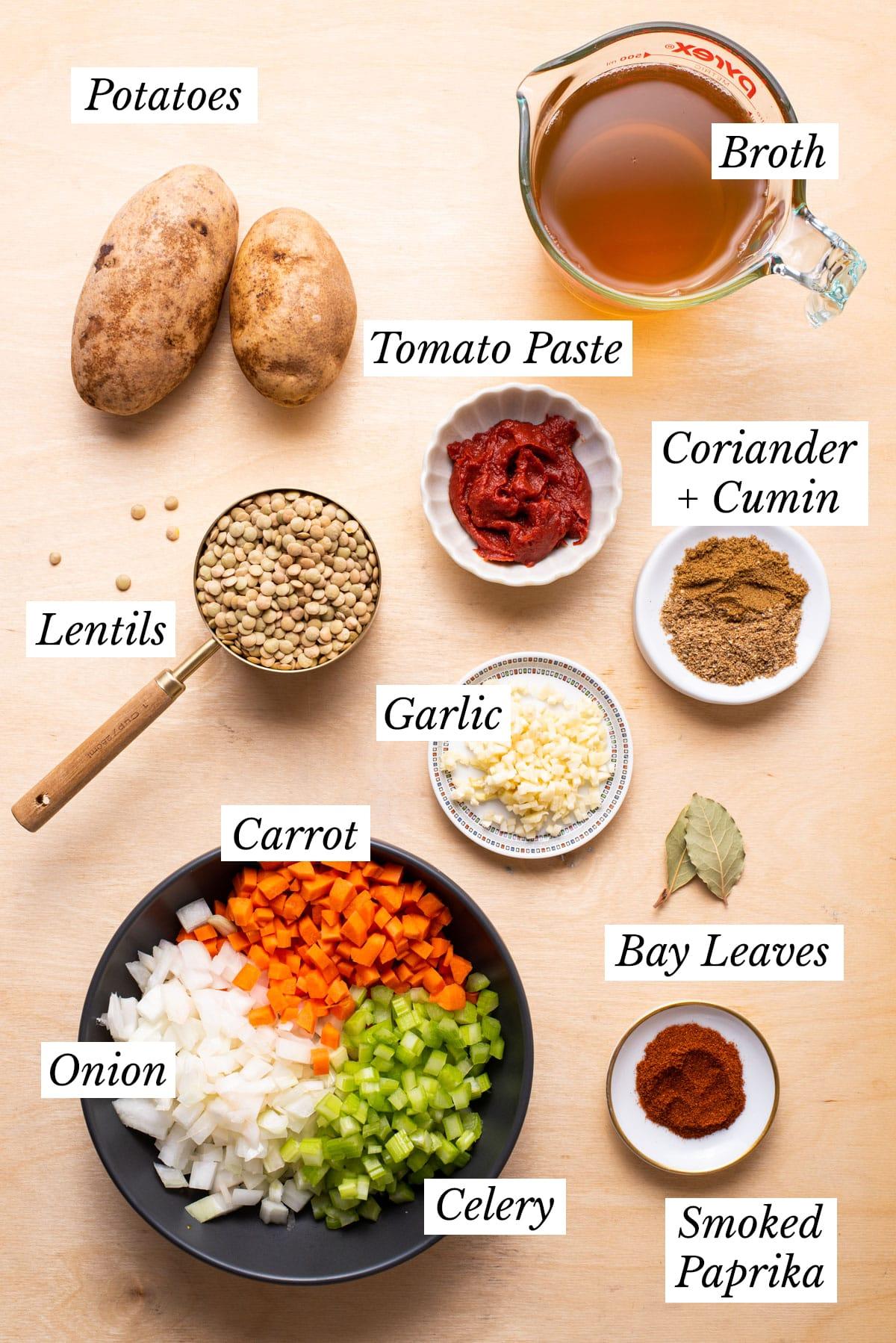 Ingredients for Moroccan lentil soup laid out on a wooden table
