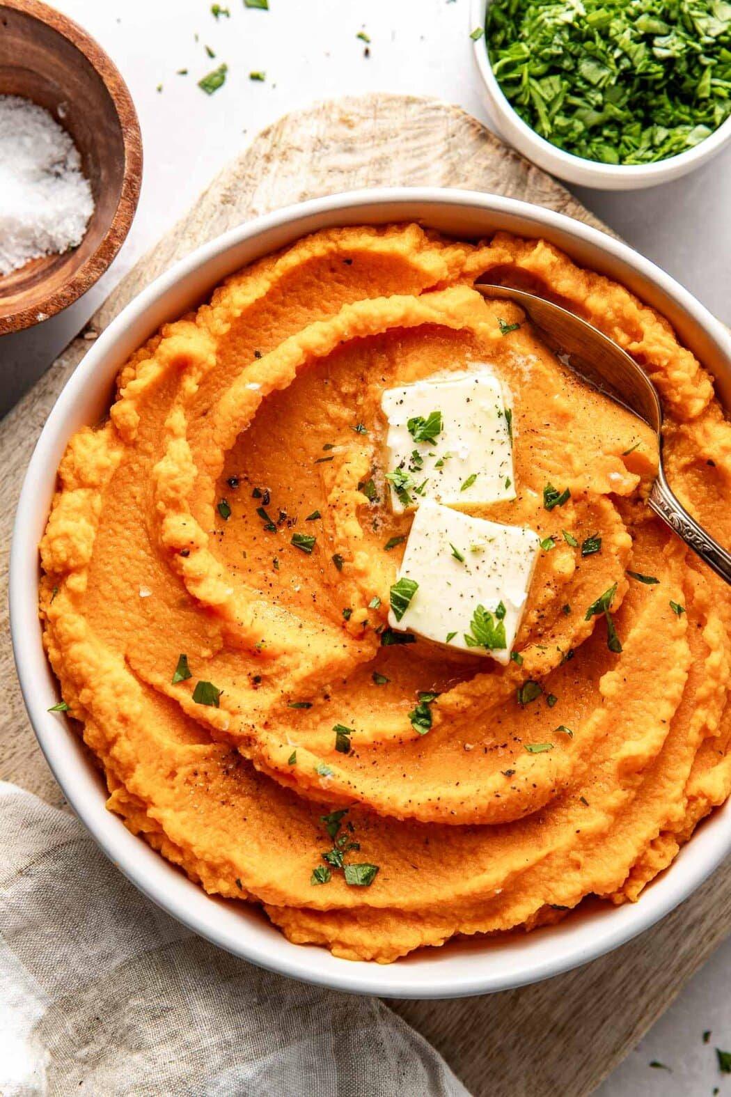 Close-up of perfectly mashed sweet potatoes in a bowl with spices