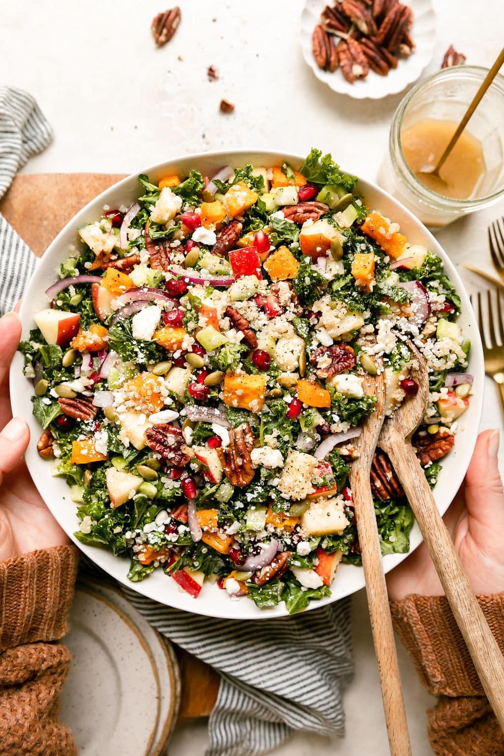 overhead view of a table set with harvest quinoa salad and other fall dishes