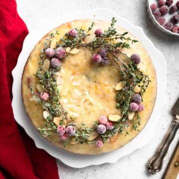 Overhead shot of pumpkin cranberry bake cooling on a wire rack, festive background