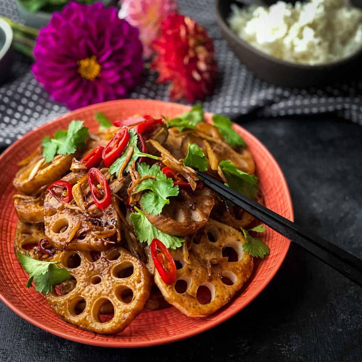 sautéed lotus root with sweet and sour sauce in a wok