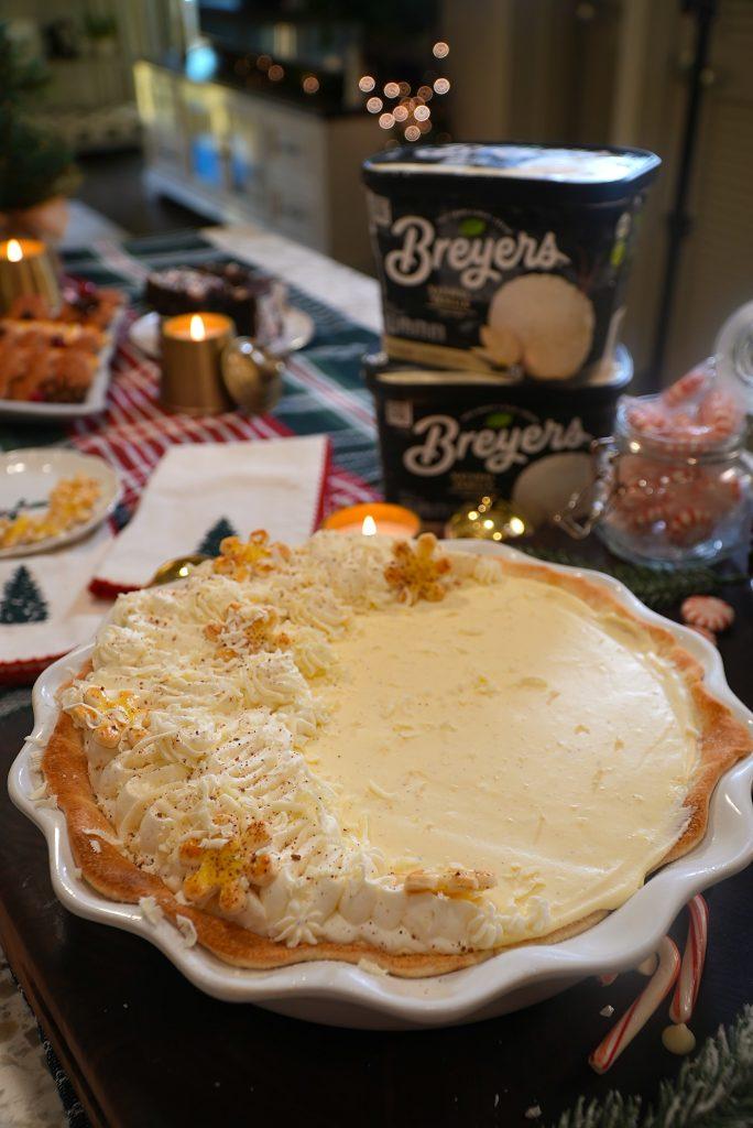 Hand holding a slice of eggnog pie with a perfect, creamy custard filling and a golden crust