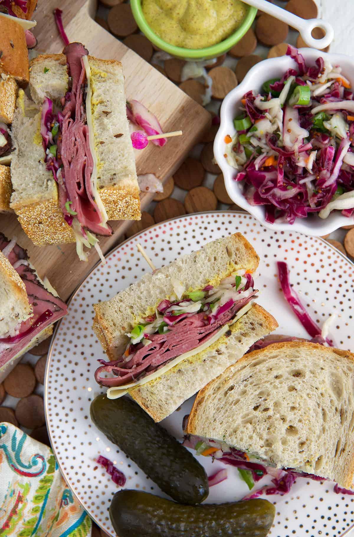 overhead shot of a completed pastrami and swiss wrap, cut in half to show the layers