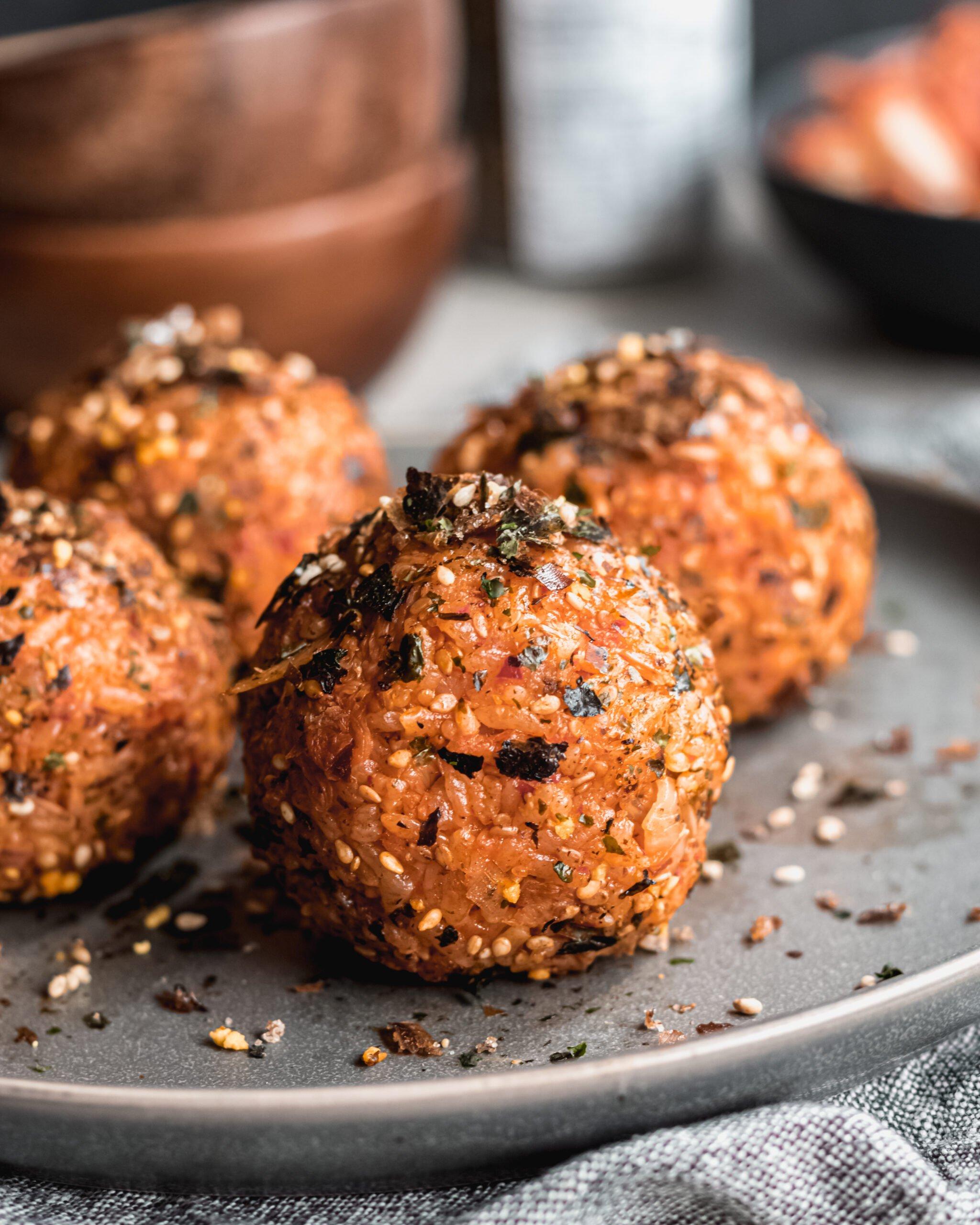 close up shot of kimchi and date energy balls being rolled by hand