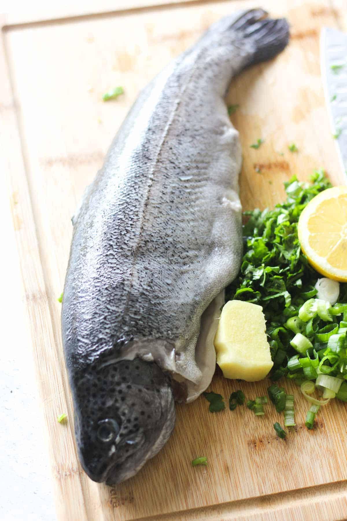 Fresh trout fillets being prepared for steaming