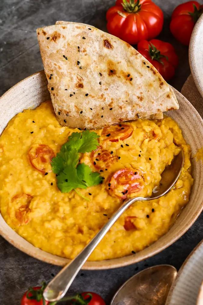 A close-up of the ingredients for creamy tomato dal.