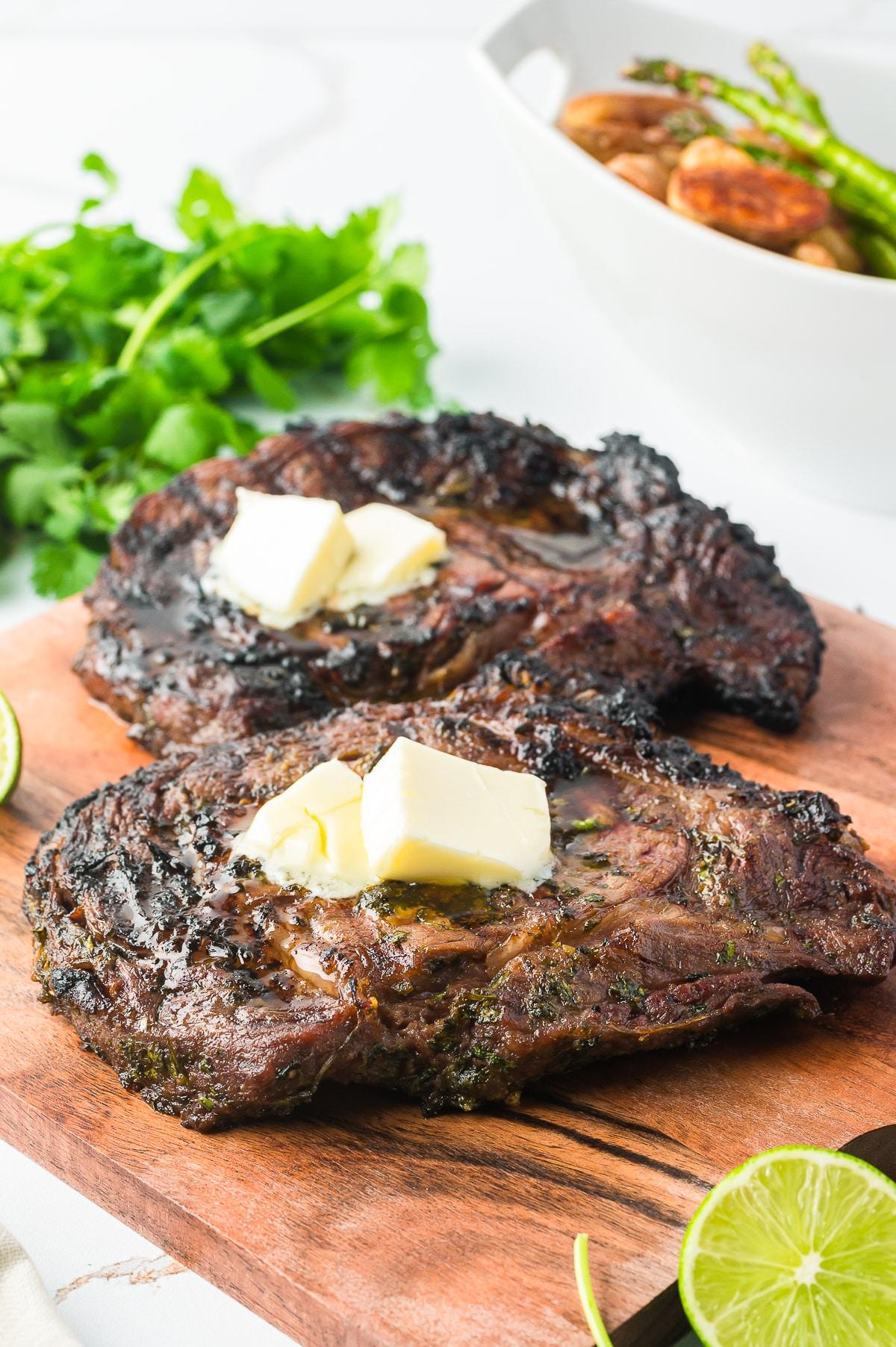 grilled skirt steak with cilantro-lime dressing being drizzled on top