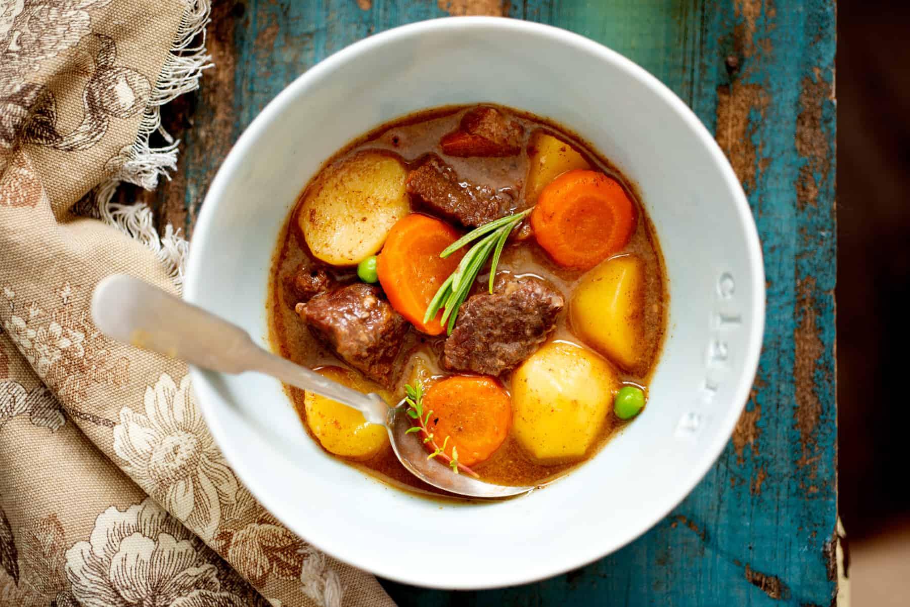 Instant Pot Beef Stew with Red Wine being served in a rustic bowl